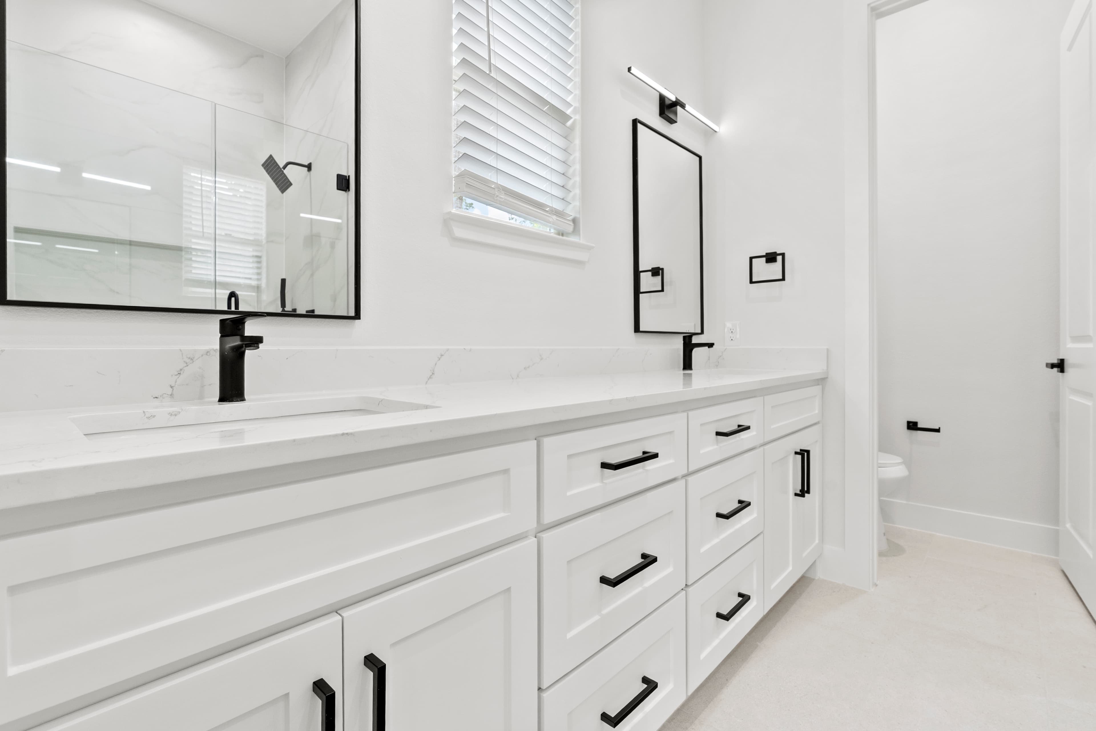 A custom double-vanity bathroom in a completed ROSÖ Homes build