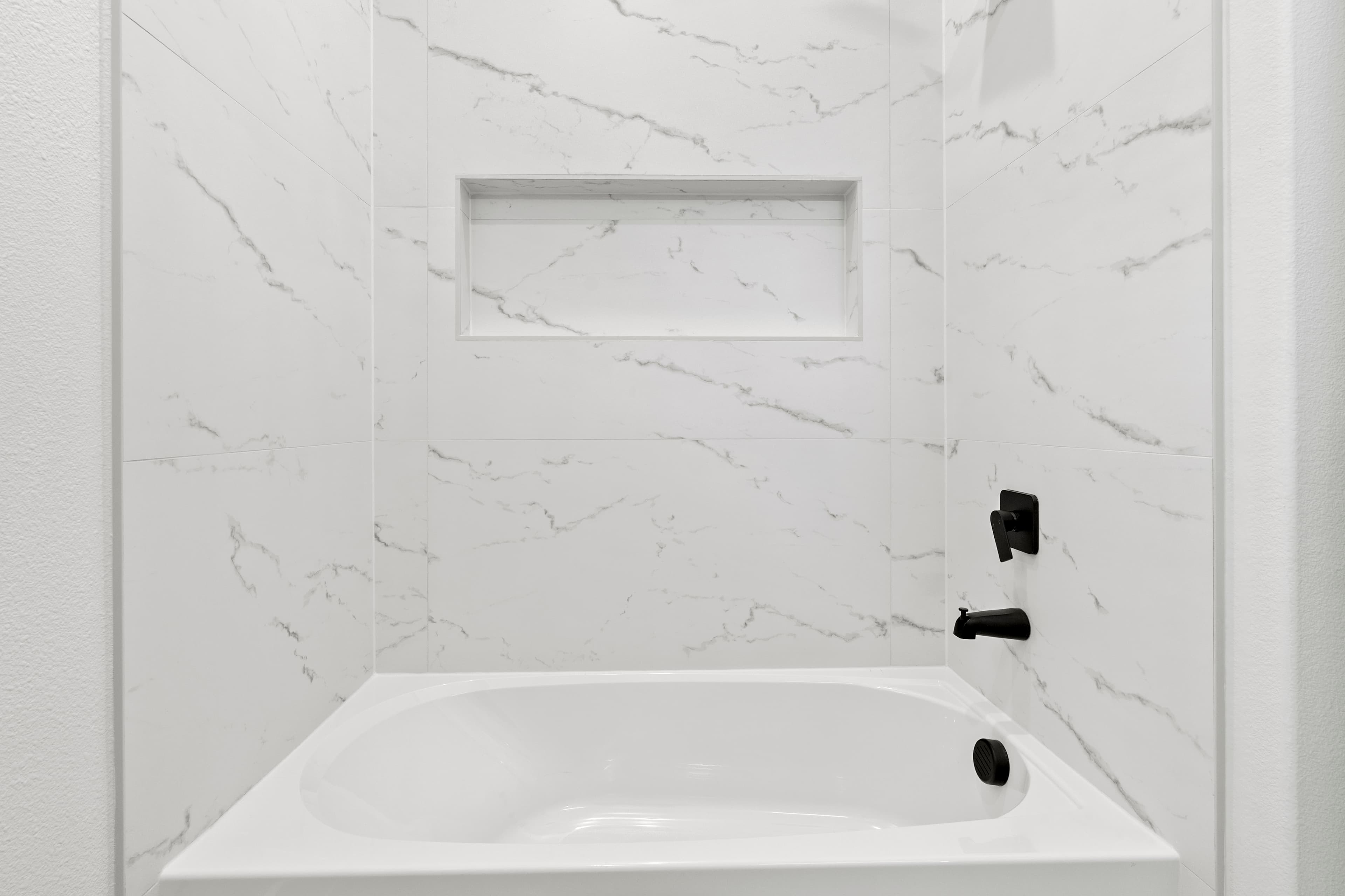 A detailed tiled bath in a completed ROSÖ Homes build