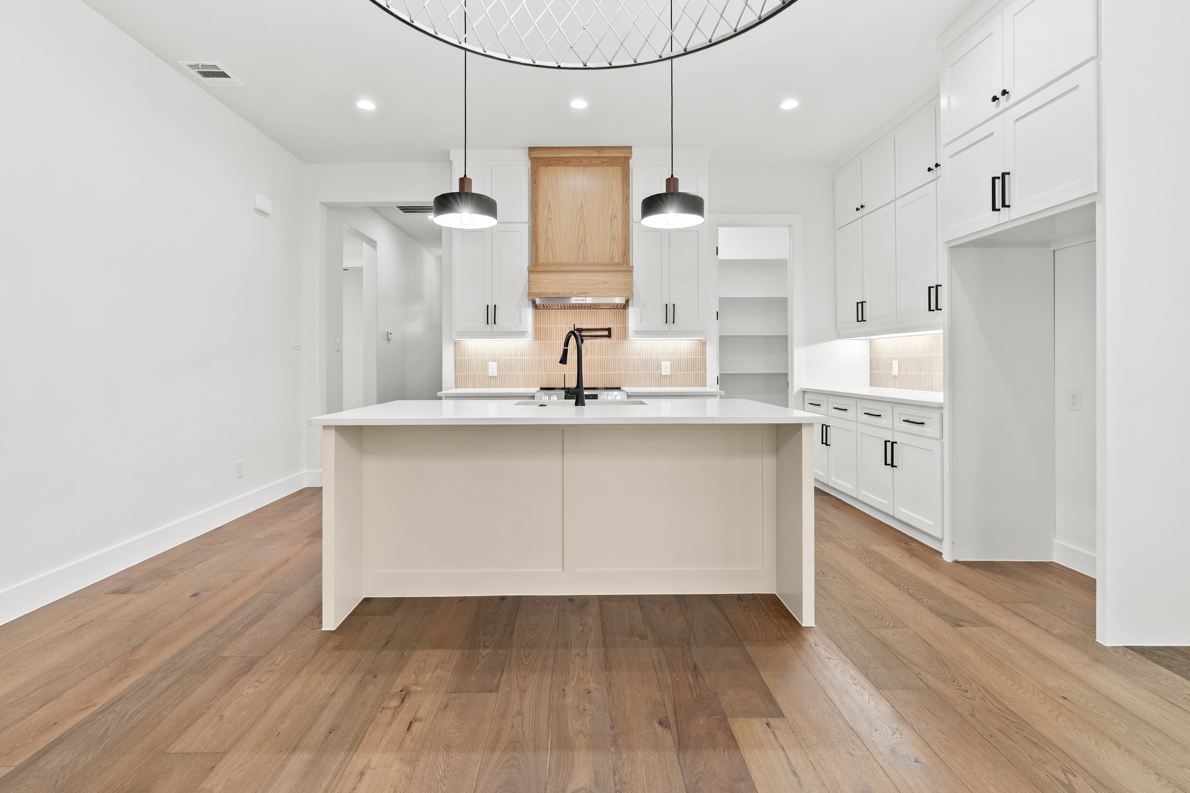 A finished ROSÖ Homes kitchen with a large island and custom cabinetry